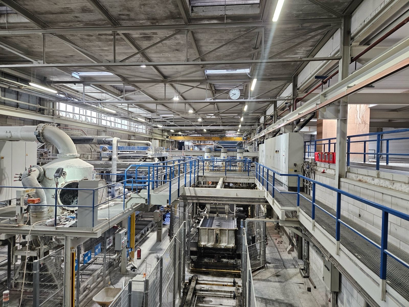 Industriële productieomgeving met machines, installaties en loopbruggen